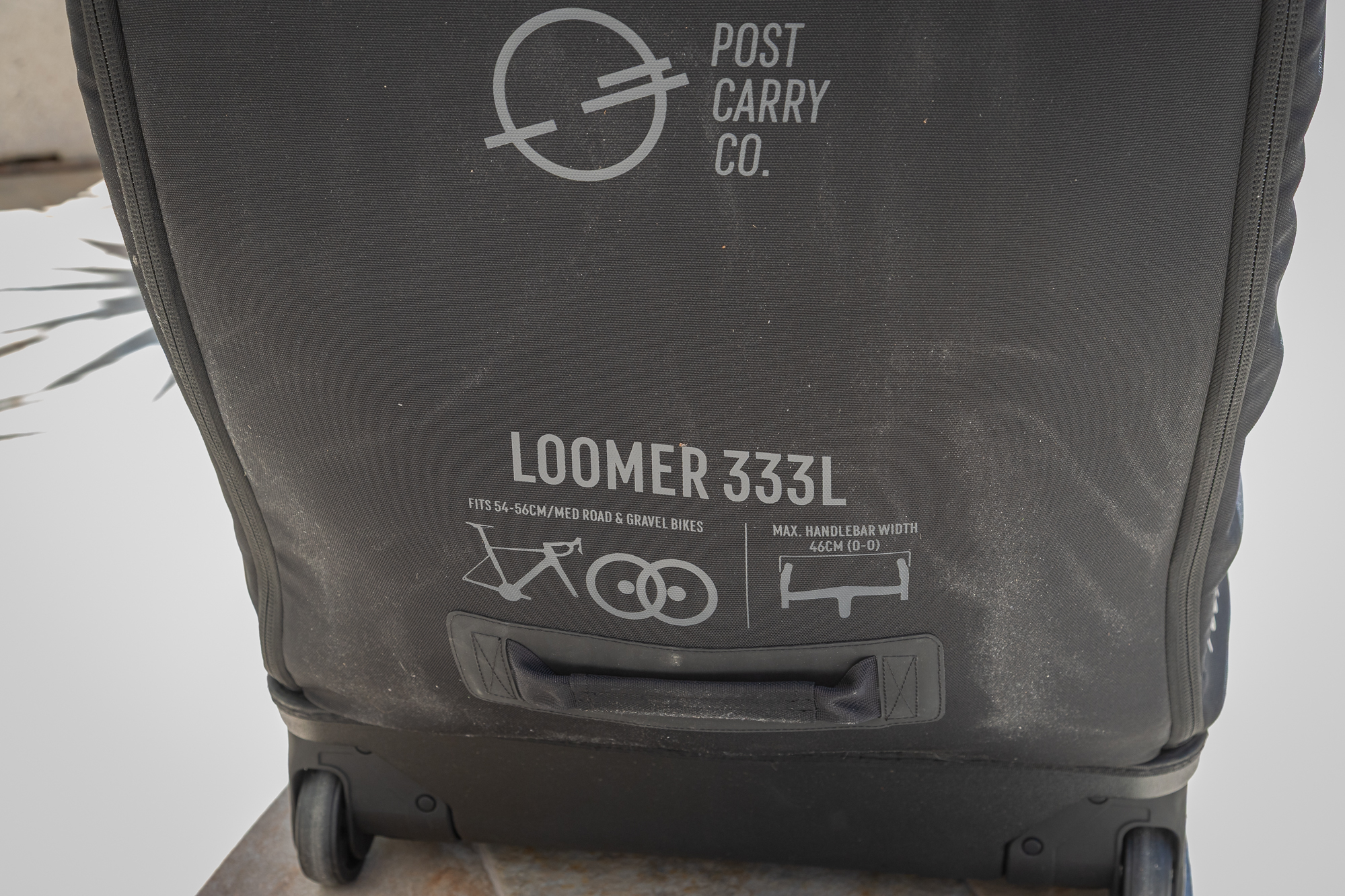 writing on the outside of a black bike box which says Loomer 333L