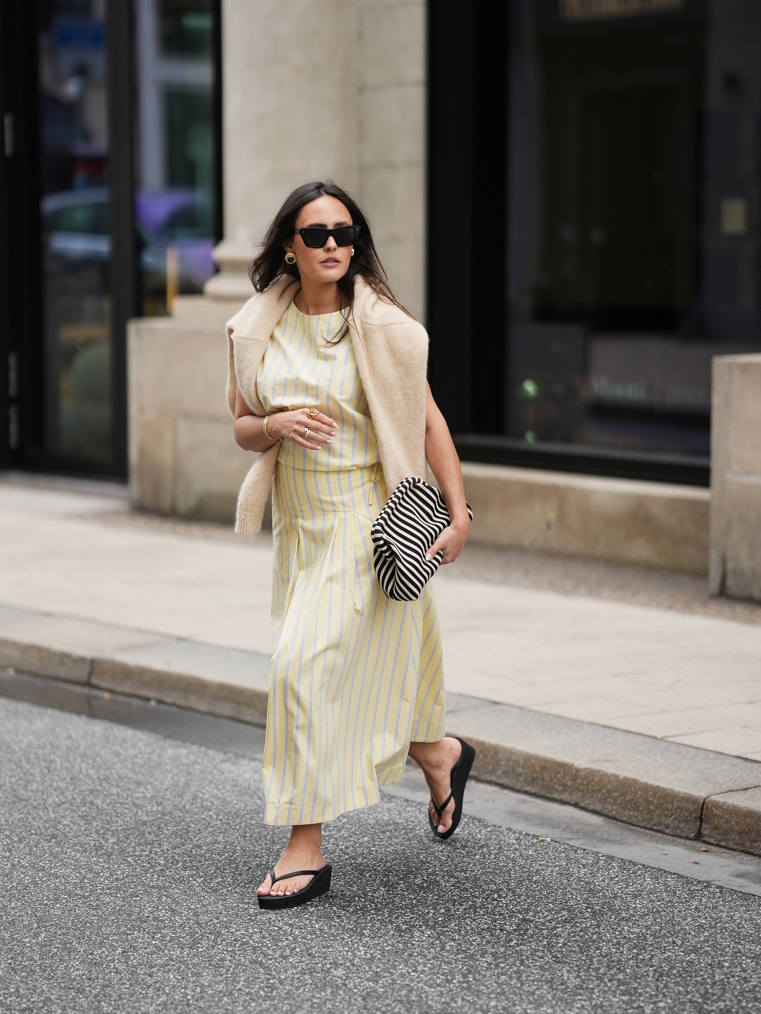woman street style wearing slip dress and sweater