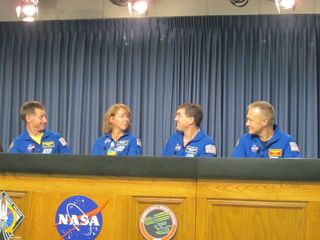 Atlantis Crew Seated at Desk During Post-Landing Press Conference