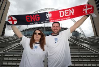 Two England fans stand outside Wembley with a half-and-half scarf (Nick Potts/PA)