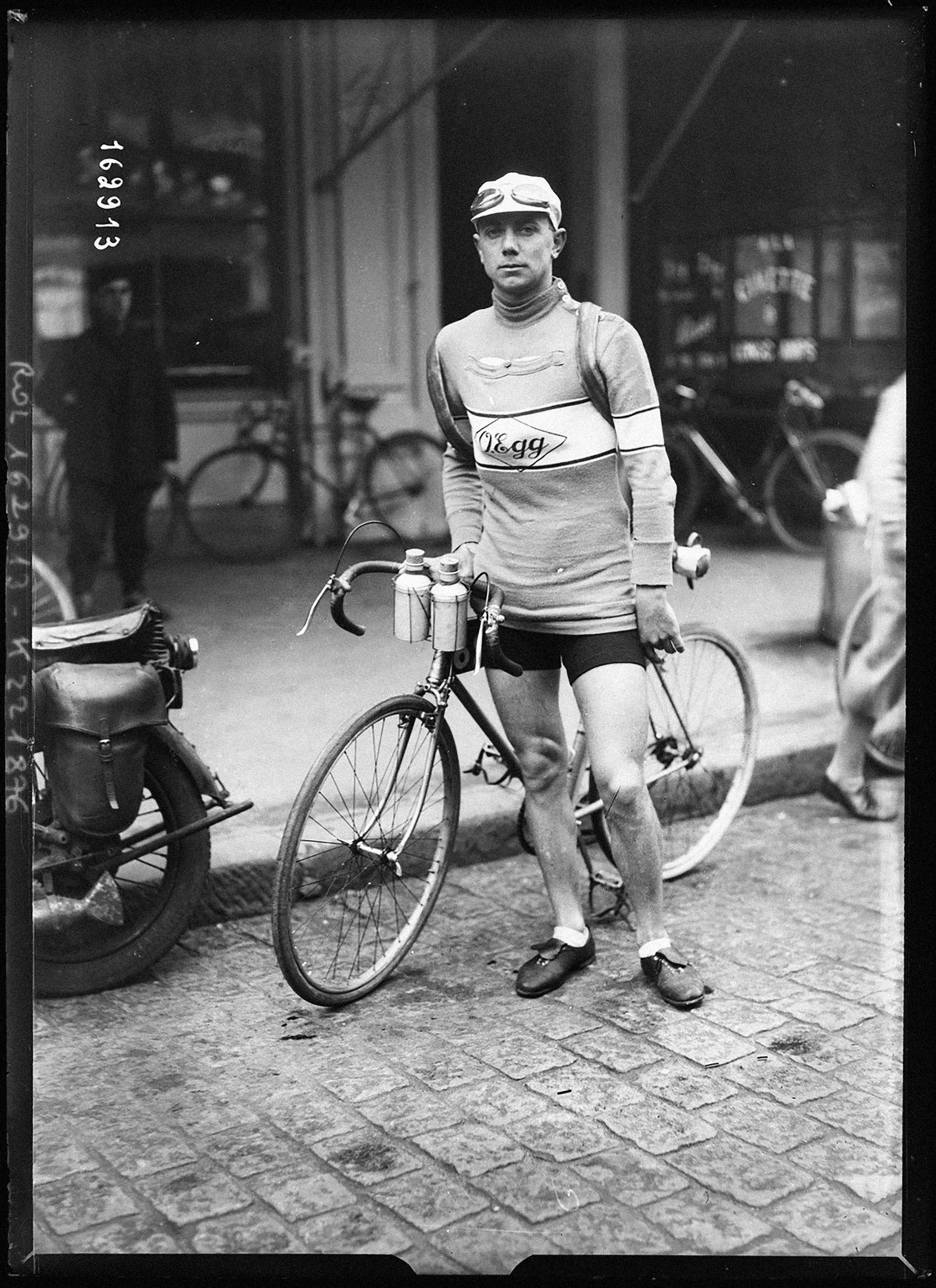 Bill Mills standing with his bike in 1932