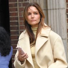 Katie Holmes wearing a butter yellow coat