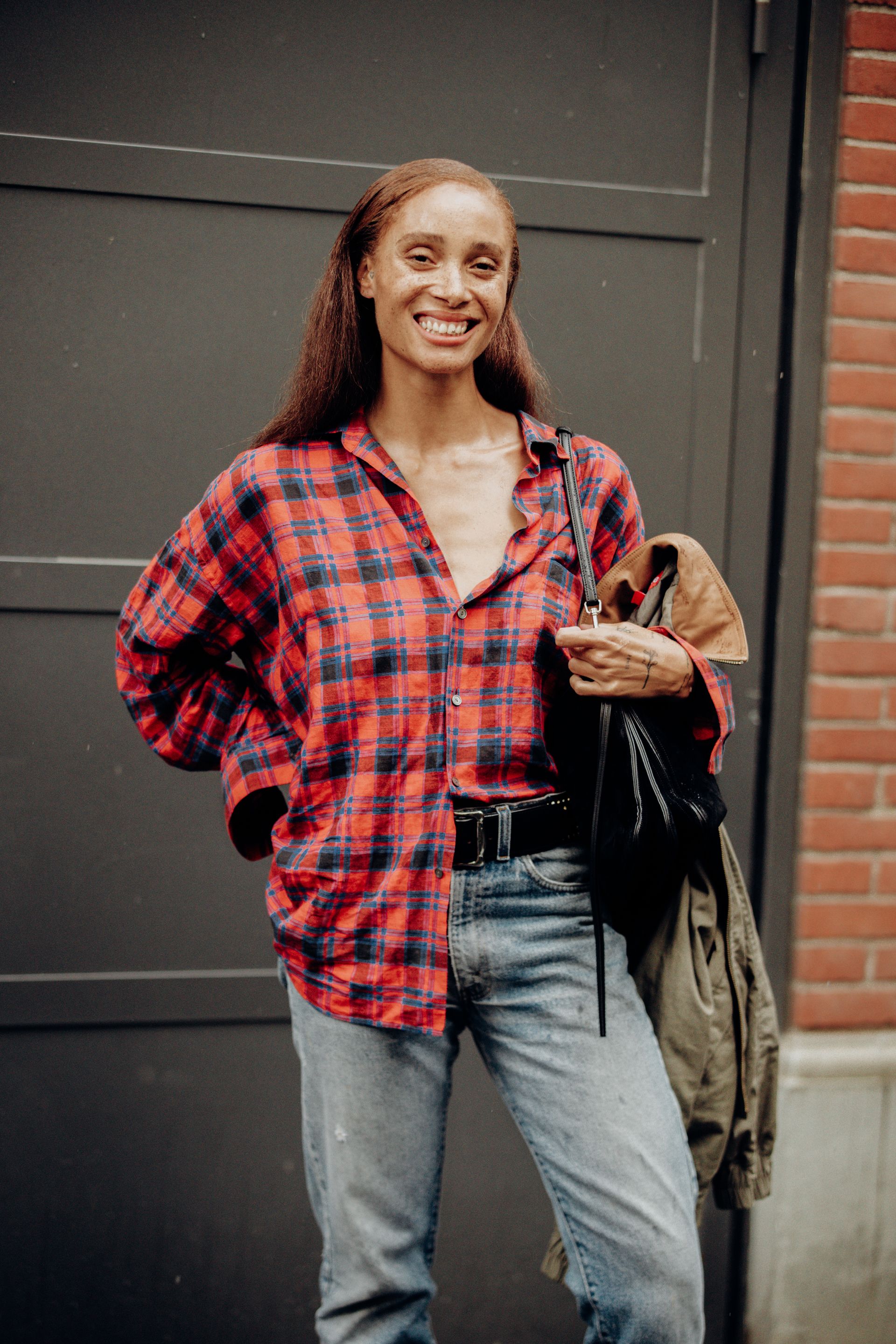 Adwoa Aboah wears the flannel shirt trend while out for London Fashion Week.