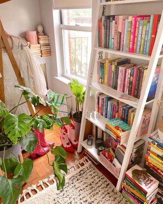 White leaning bookshelf and colorful books