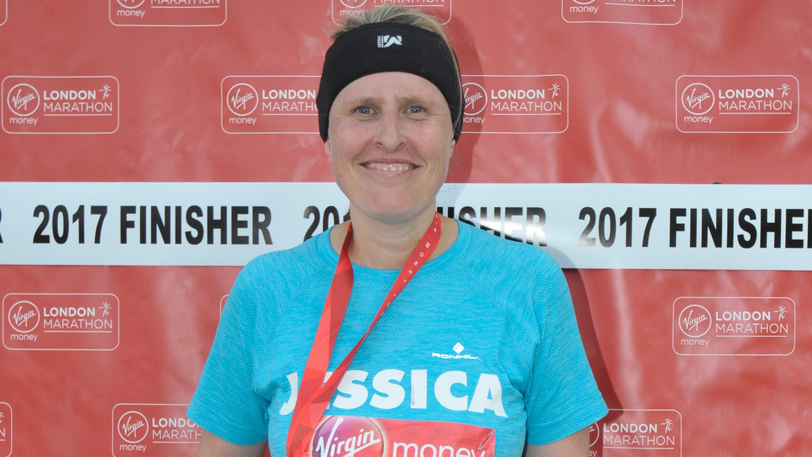 Jessica Hepburn smiling with her London Marathon 2017 medal