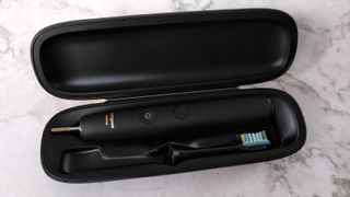 Philips Sonicare DiamondClean 9000 electric toothbrush and brush head inside charging case