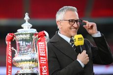 BBC presenter Gary Lineker looks on with the FA Cup trophy