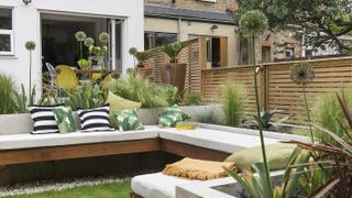 Built in sunken seating with alliums in raised beds