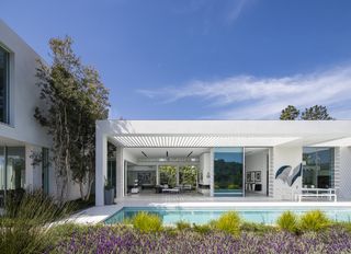 Garden view with pool house and swimming pool at Castlegate Residence in USA