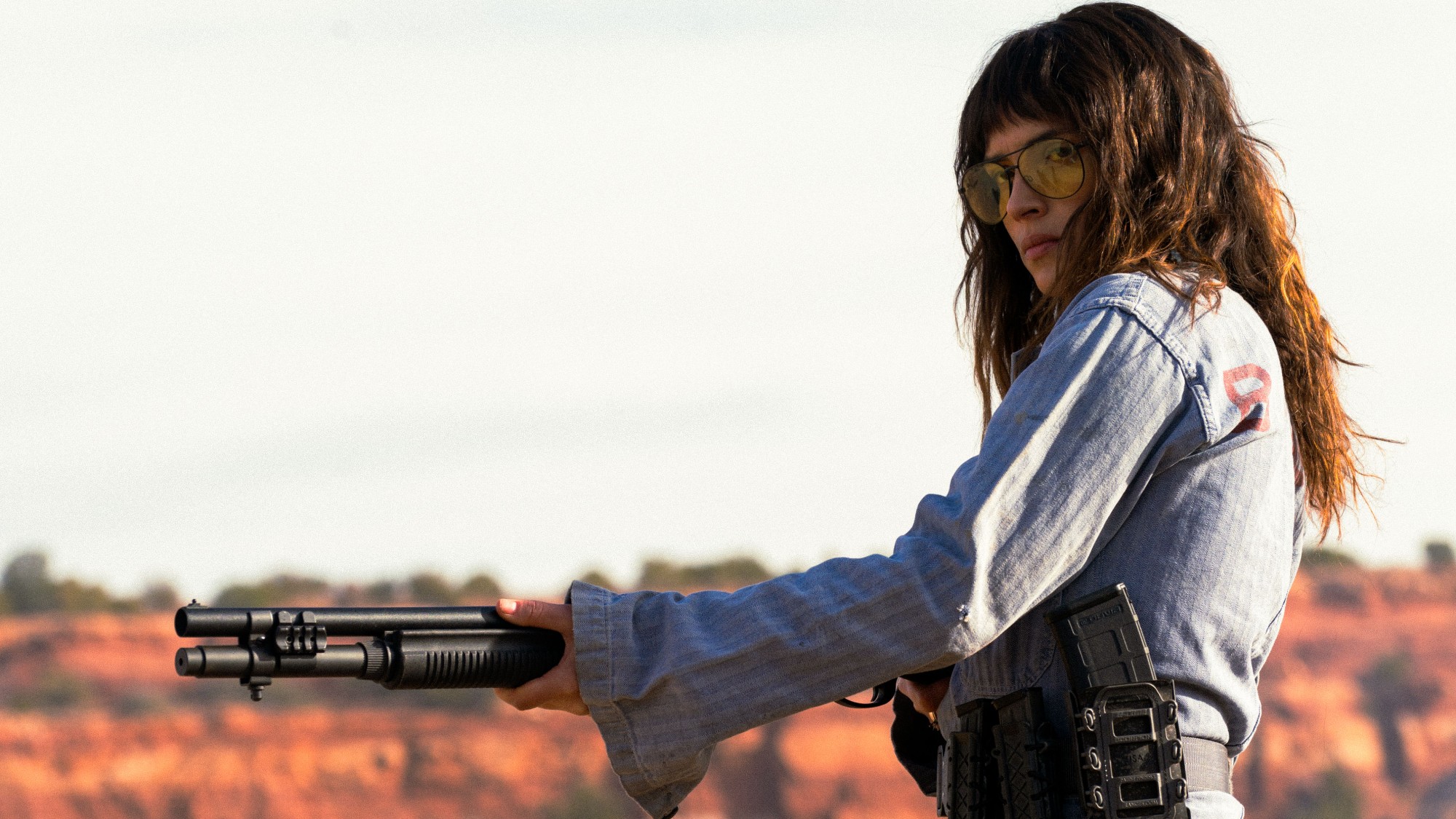 Adria Arjona holding a gun in Onslaught
