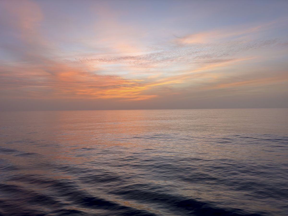Photo of golden hour over a calm ocean, taken using the iPhone 15 Pro Max with Fjorden grip