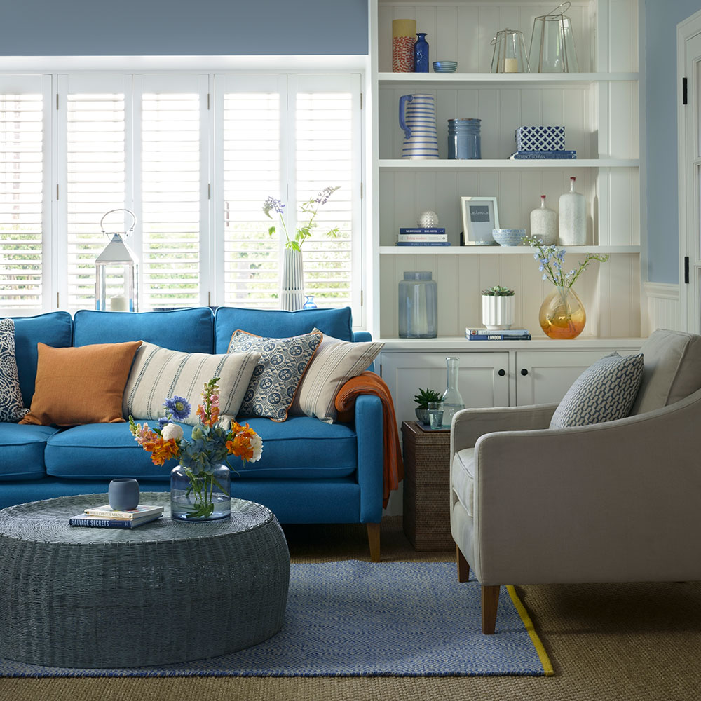 living room with shelves and grey sofa