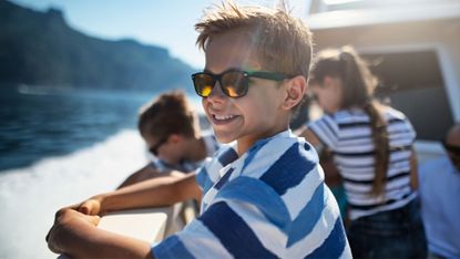 Portrait of kids enjoying ferry boat ride near Amalfi coast, Italy 
