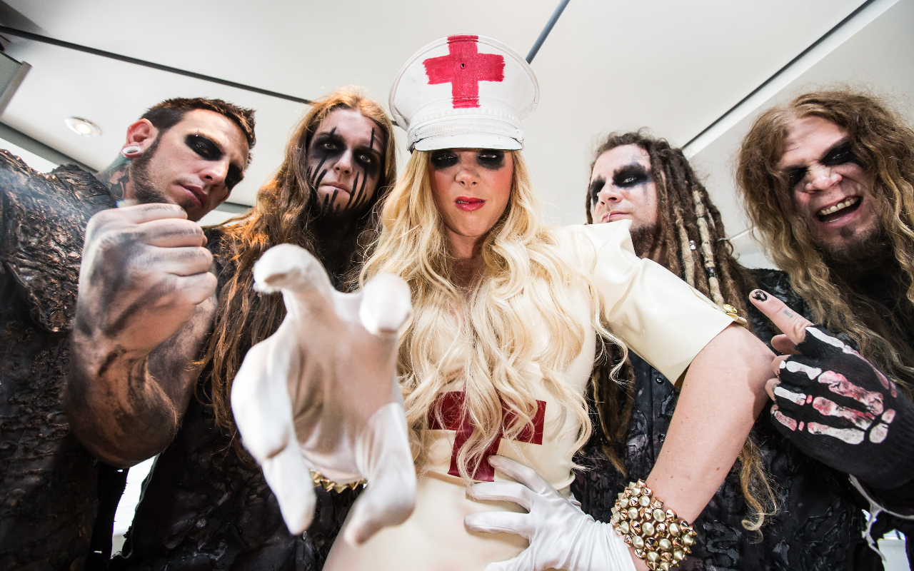 In This Moment in stage gear pointing at the camera