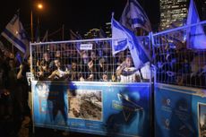 Protesters in Israel behind a gate