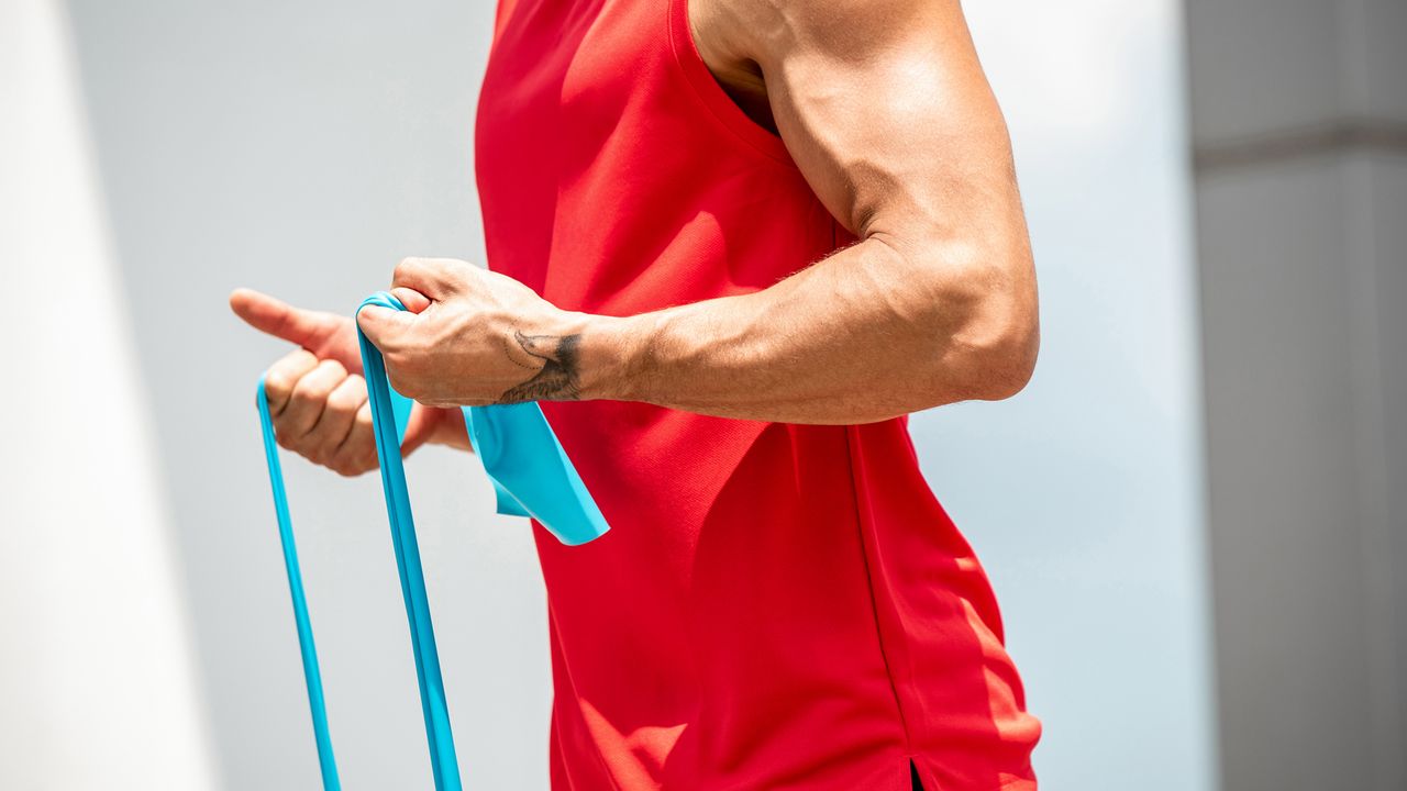 Person works out their upper arms with a resistance band