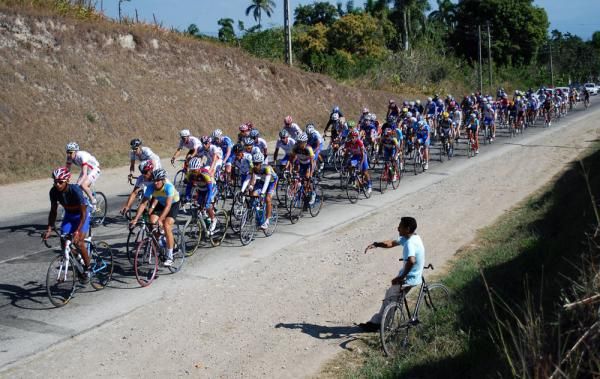 A lone fan cheers on the peloton