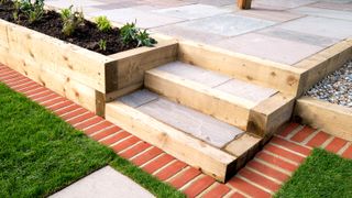 Newly laid garden with wooden garden sleepers for edging