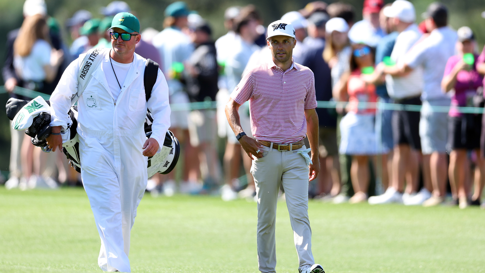 Eric Cole of the United States walks with his caddie on the eighth hole during a practice round prior to the 2024 Masters.