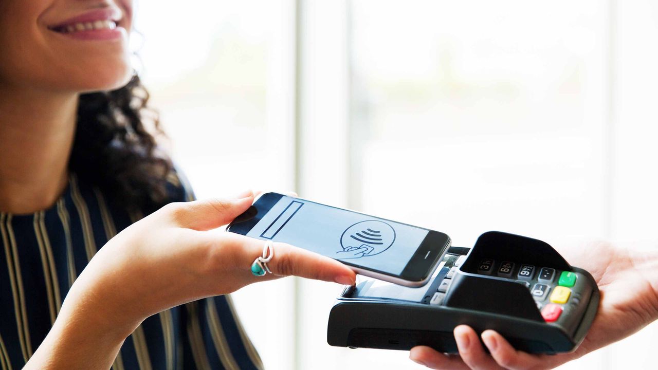 woman using phone to make a payment