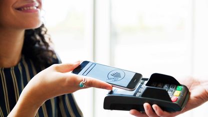 woman using phone to make a payment