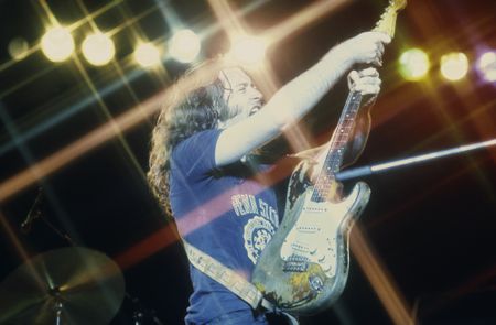 Rory Gallagher wields his heavily-worn '61 Fender Stratocaster onstage in London in 1975