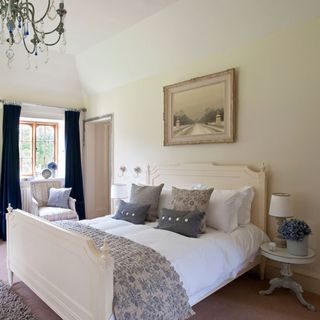 bedroom with chandelier and bedlinen