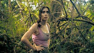 Cristin Milioti, as Emma, stands in a forrest in The Resort