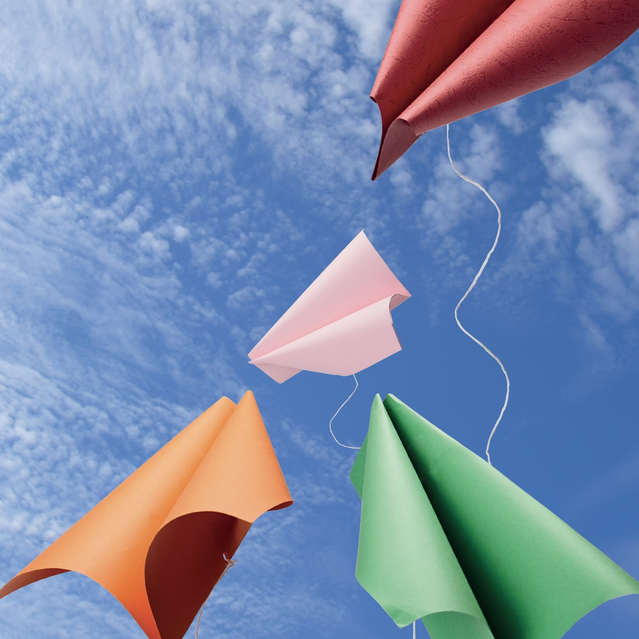 paper kites on sky background