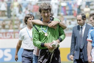 France goalkeeper Philippe Bergeroo is jumped on by team-mate Michel Platini after Les Bleus' win over Belgium to finish third at the 1986 World Cup.