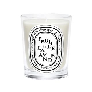 A white Diptyque candle