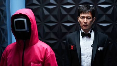 Lee Jung-jae as Gi-hun with a Pink Guard in Squid Game season 3