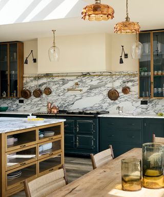 devol green kitchen with a large range cooker and hood and marble counters