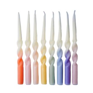 Eight rainbow colored twisted candles