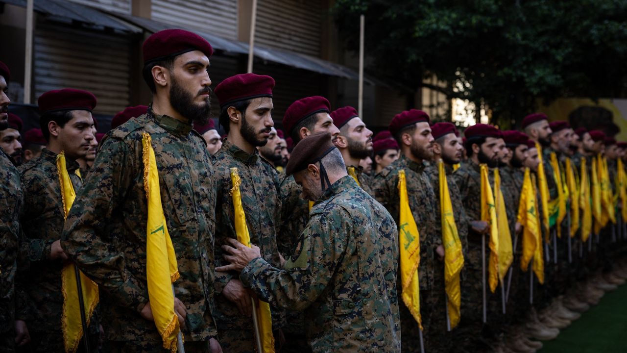 Fighters stand to attention at the funeral of Hezbollah commanders Ibrahim Aqil and Mahmoud Hamad, killed in an Israeli airstrike on a residential building in Beirut