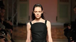 Woman in black dress on catwalk