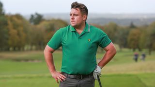 A man wears a Lyle & Scott Golf Team Tipped Polo Shirt
