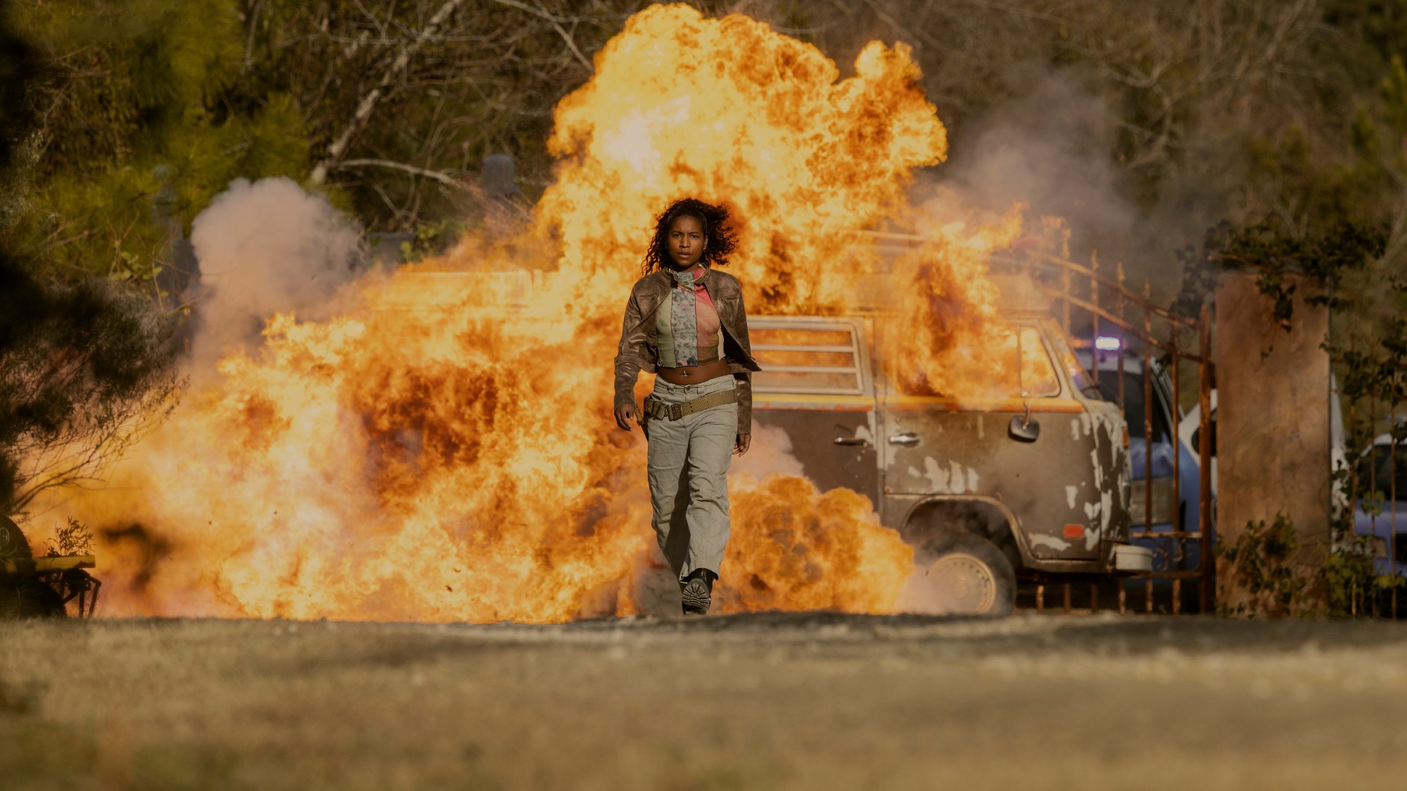 Carlacia Grant as Cleo walking away from an exploding van.