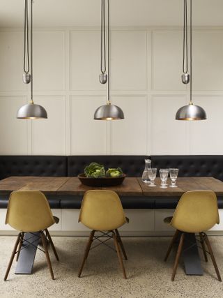 a trio of pendant lights in modern dining room by Davey