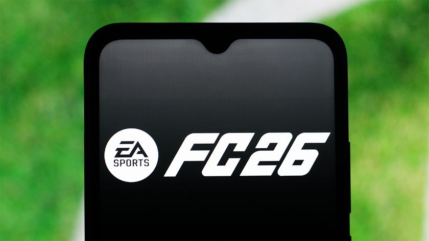 EA FC 26 logo displayed on a smartphone with the grass of a football pitch in the background