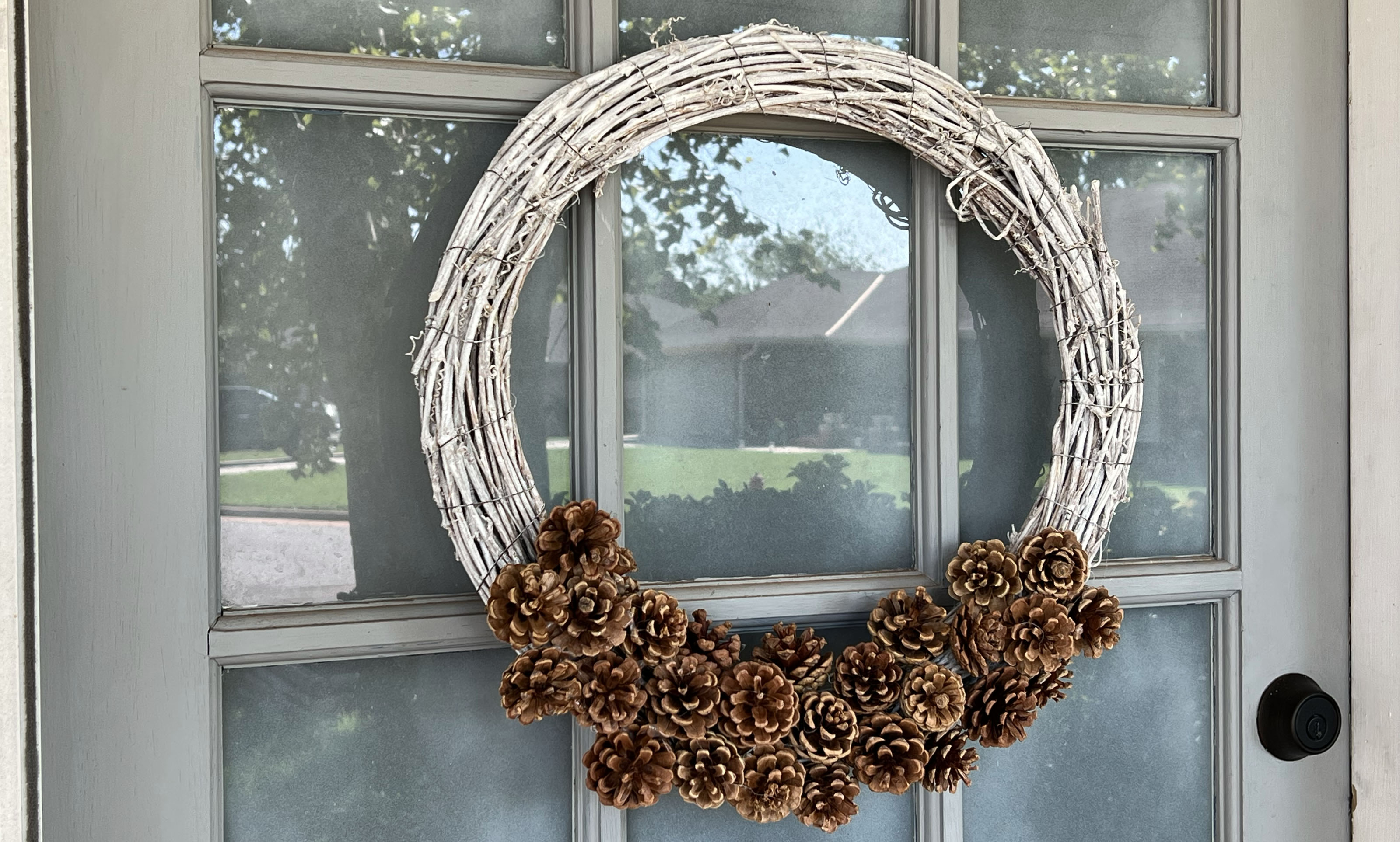 pinecone wreath on front door