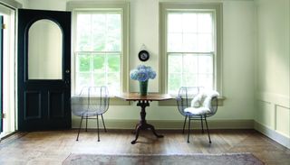 Double hung windows with painted door frame in blue and intense white walls