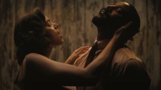 Hailee Steinfeld holds Michael B Jordan's head while examining his neck in Sinners.