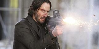 Keanu Reeves as John Wick firing a gun