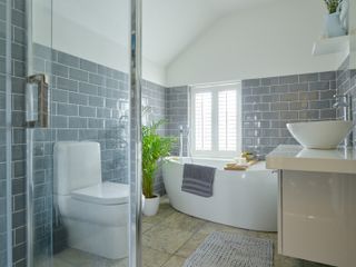a modern, practical bathroom with grey metro tiles