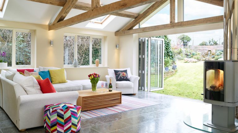 A fresh, modern extension, garden room with wood burner & view of the garden through bi-fold doors