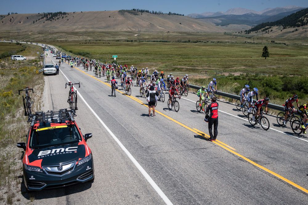 The peloton makes its way through the feed zone