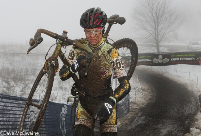Ellen Sherrill (Bicycle Bluebook) using classic cyclocross form to ascend the stairs