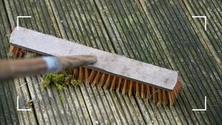 picture of brush sweeping dirty decking