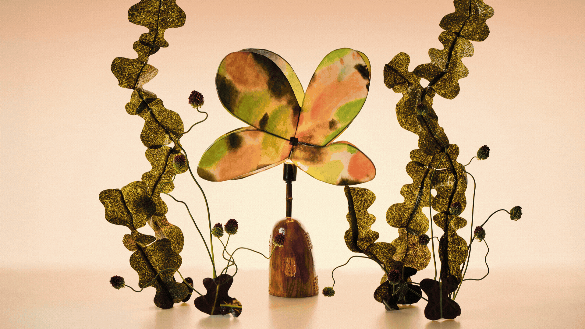Rotating GIF showcasing different new homeware releases from different brands. There is a neutral living room, an artisanal lamp, a big green egg grill, and white ceramic lamps.
